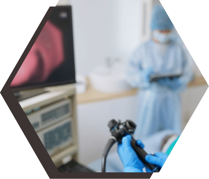 Physician performing a colonoscopy procedure to screen for colorectal cancer.